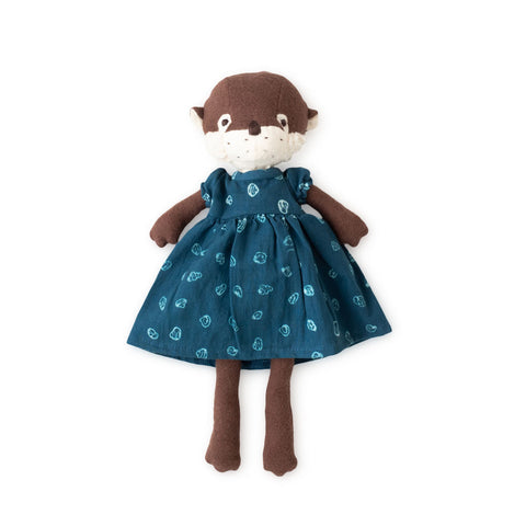 clara otter wearing riverbank dress flat lay
