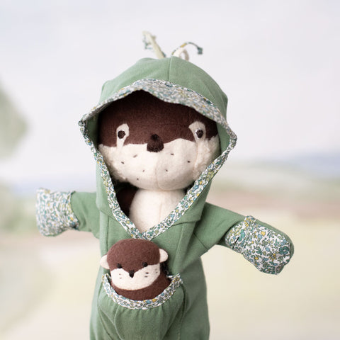 portrait of clara otter wearing Après Swim Lounge Suit, with mini otter in the pocket