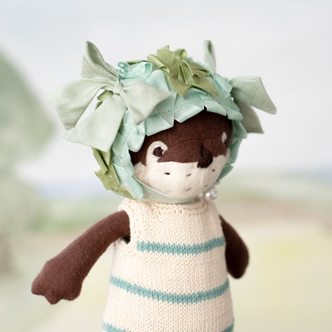 clara otter wearing striped swimsuit and pondweed swim cap