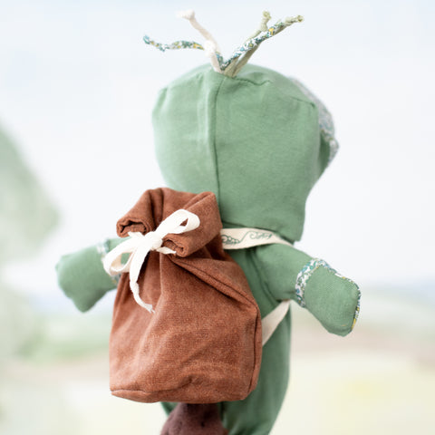 angled back view portrait of clara otter wearing dry bag backpack with aprés swim lounge suit