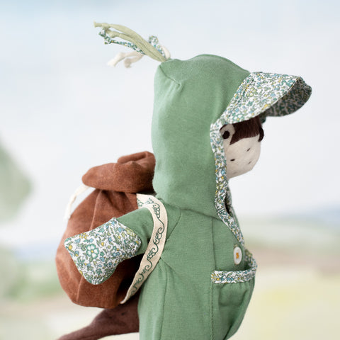 side view portrait of clara otter wearing dry bag backpack with aprés swim lounge suit