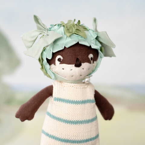portrait of clara otter wearing pondweed swim cap and striped swimsuit