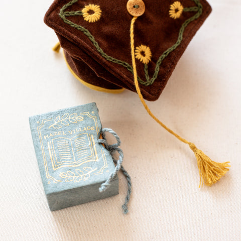 library books box set lokta paper box with gold decoration, next to Thinking Cap