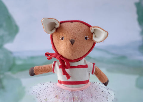 Phoebe Fawn wearing red bonnet, romper, and tutu